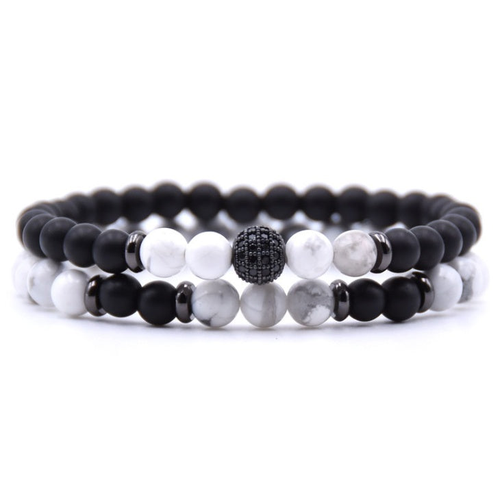Close-up of 6mm natural stone beads with micro-zircon rune patterns.