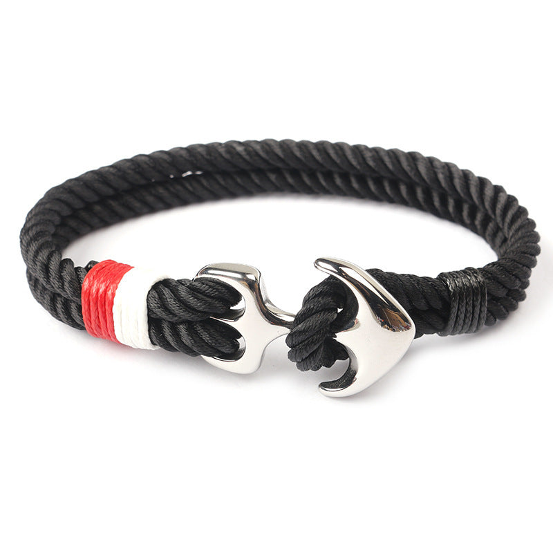 Close-up of zinc anchor detail on braided marine rope bracelet.