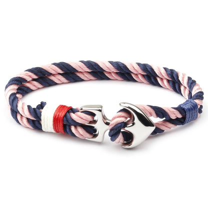 Anchor charm marine bracelet on weathered dock wood, showing rope texture.